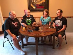 Four podcasters sitting at a table